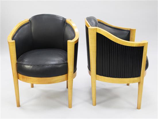 A pair of Art Deco satin birch and black leather upholstered tub chairs, by Maurice Adams,